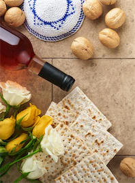 tiny-passover-celebration-concept-matzah-kosher-red-wine-walnut-white-yellow-roses-traditional-ritual-jewish-bread-sand-color-old-tile-wall-background-passover-food-pesach-jewish-holiday